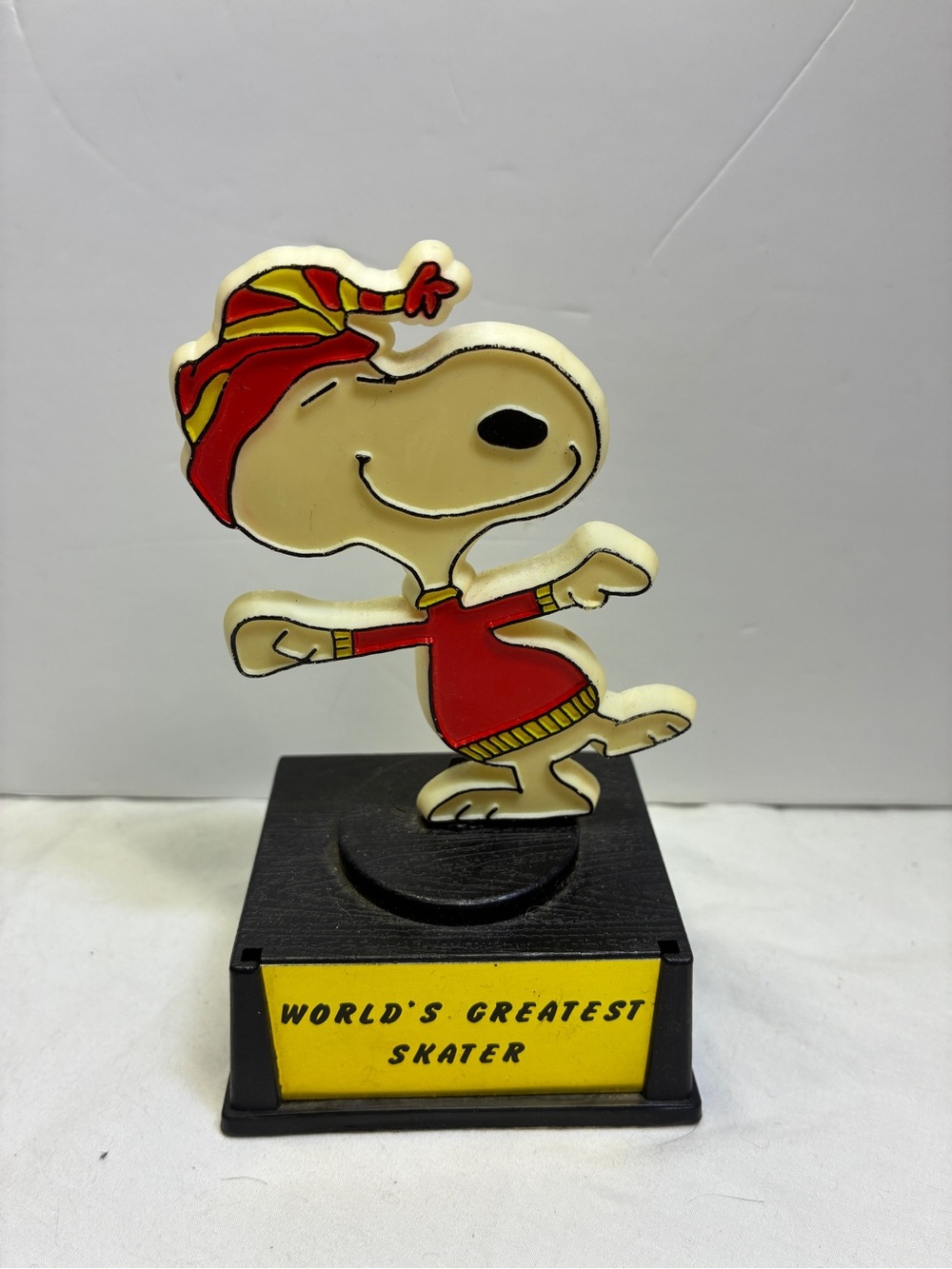 Vintage 1970s Aviva Peanuts Snoopy trophy labeled "World's Greatest Skater".